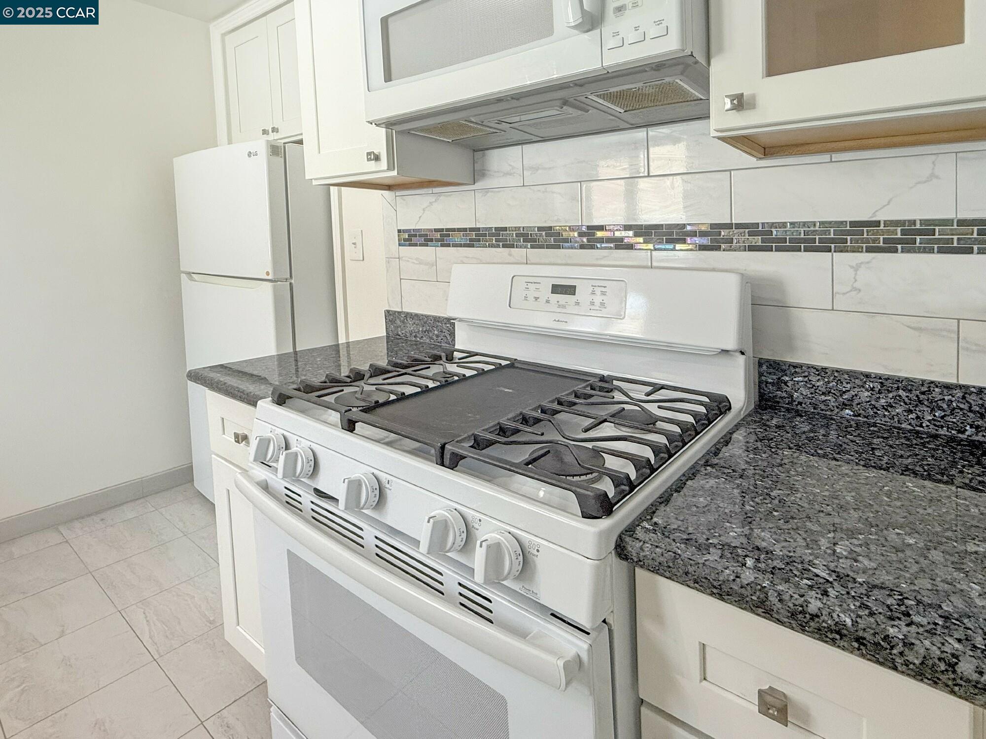 1919 Curtis Street Berkeley, CA 94702 - Photo 41 of 54 a white stove top oven sitting inside of a kitchen
