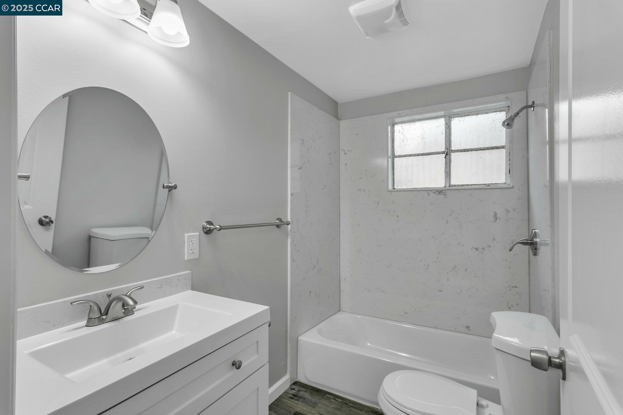 1919 Curtis Street Berkeley, CA 94702 - Photo 51 of 54 a bathroom with a sink toilet and shower