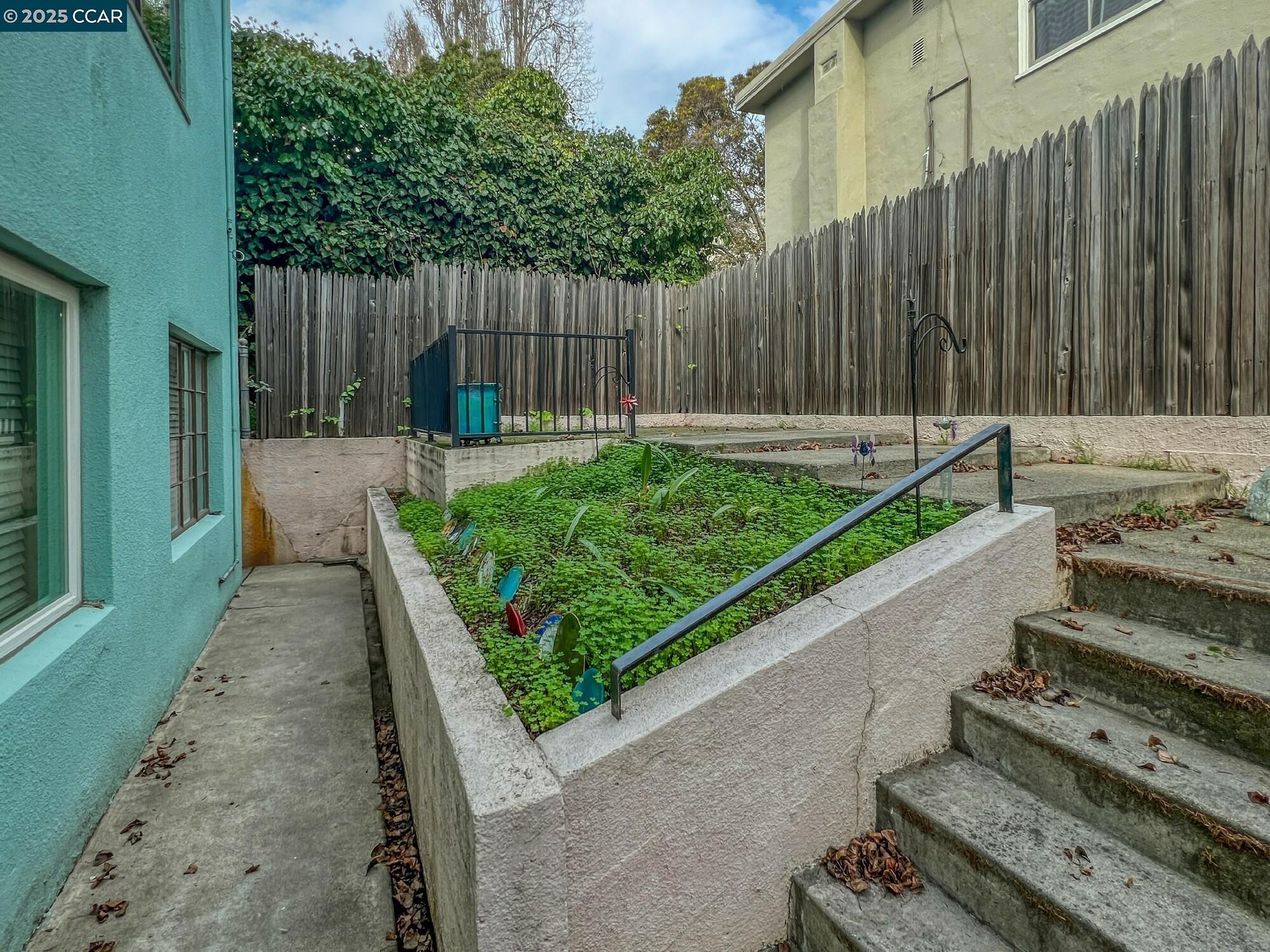 1919 Curtis Street Berkeley, CA 94702 - Photo 6 of 54 a view of a backyard with wooden fence