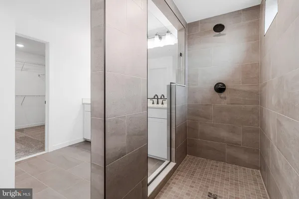a bathroom with a double vanity sink a toilet and a mirror
