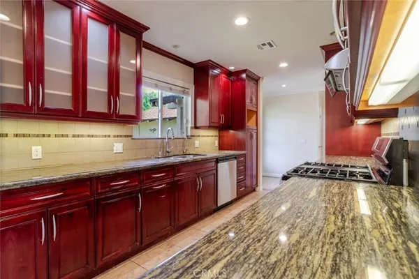 a kitchen with a sink stove and cabinets