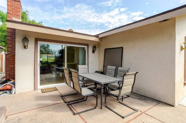 a view of a patio with a table and chairs