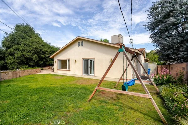 a house that has sitting area in front of it