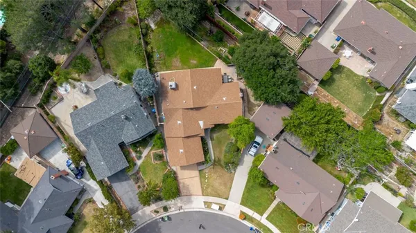an aerial view of multiple houses with yard