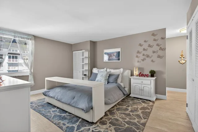 a bedroom with a large bed and a couch