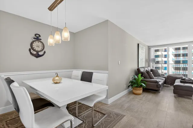 a view of a dining room with furniture and chandelier