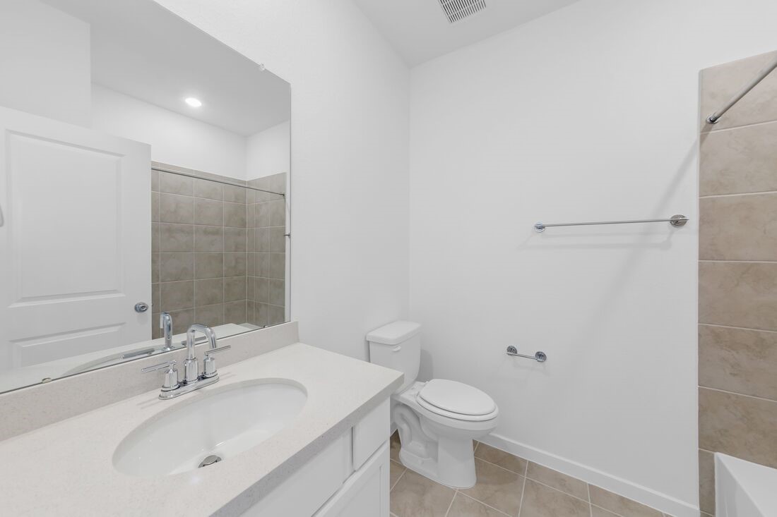 1107 Mattinson Rae Court Tomball, TX 77375 - Photo 11 of 32 a bathroom with a toilet a sink and a mirror