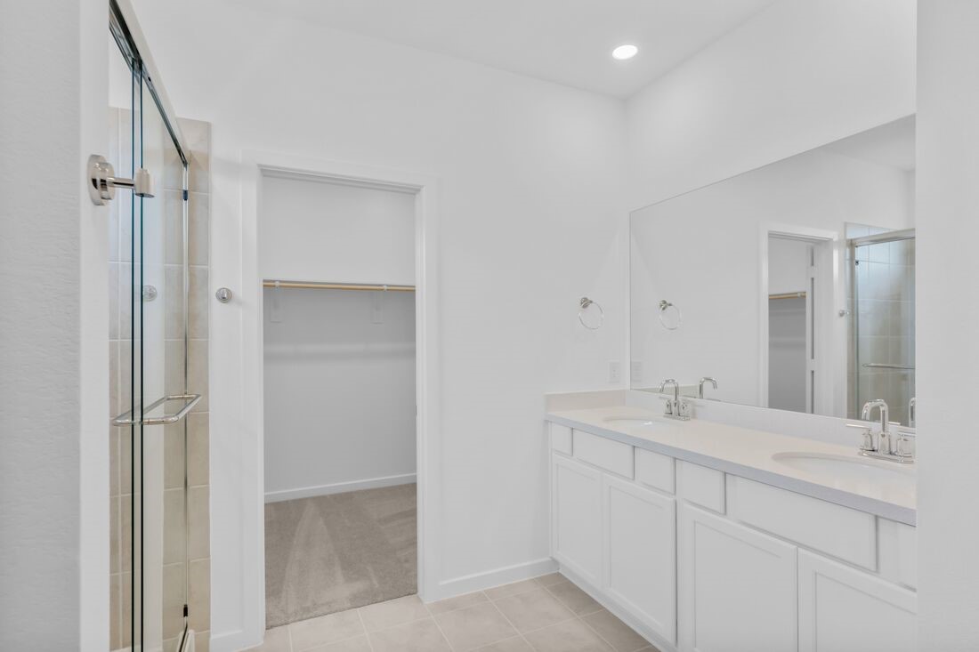 1107 Mattinson Rae Court Tomball, TX 77375 - Photo 8 of 32 a bathroom with a double vanity sink mirror and shower