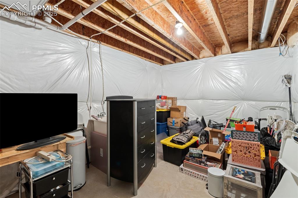 4139 Pk Hvn View Colorado Springs, CO 80917 - Photo 21 of 33 a storage room with furniture and a fireplace