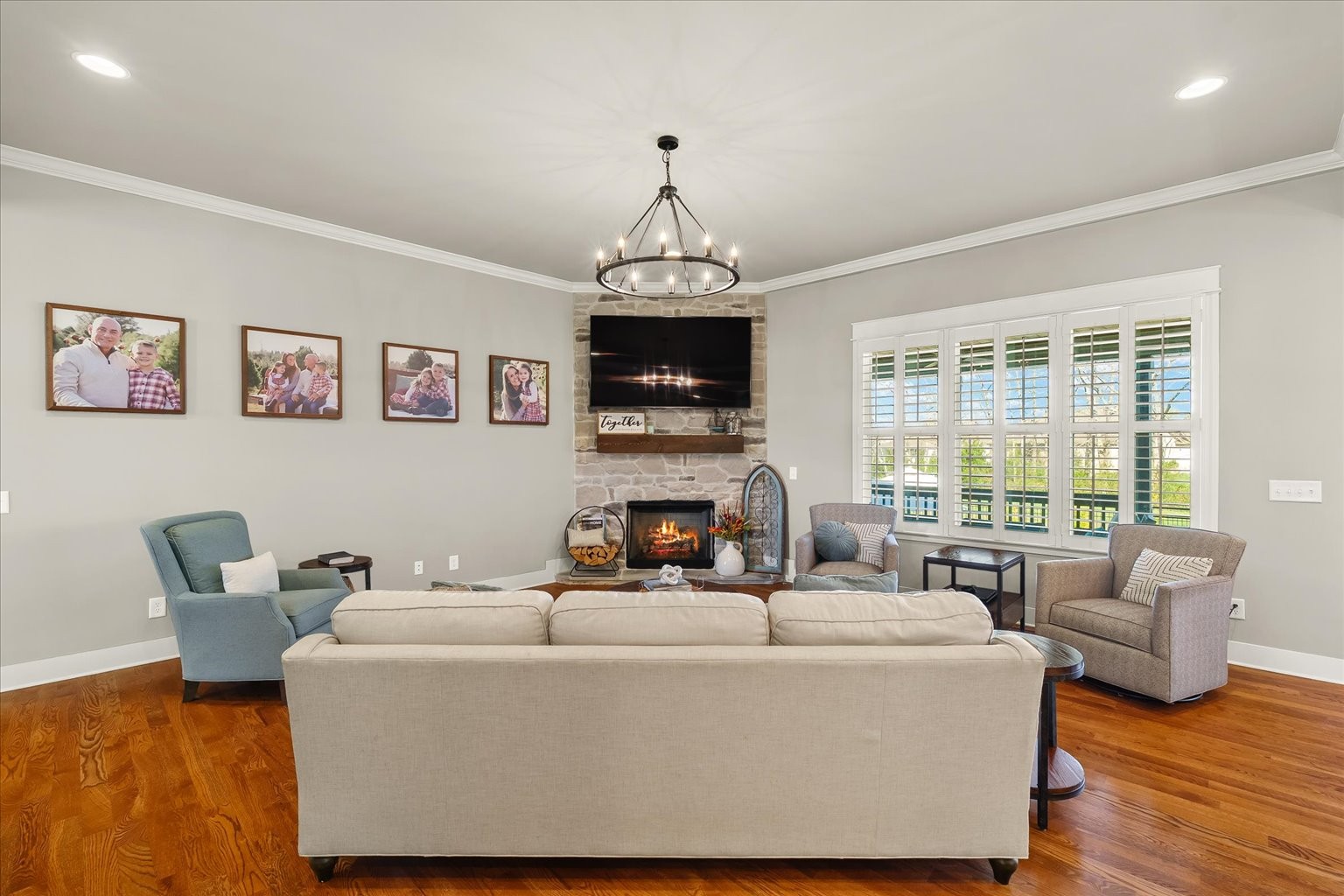 1032 Abbey Rd Way Spring Hill, TN 37174 - Photo 22 of 68 a living room with furniture a fireplace and a chandelier