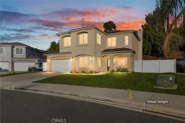 a front view of a house with a garden and plants