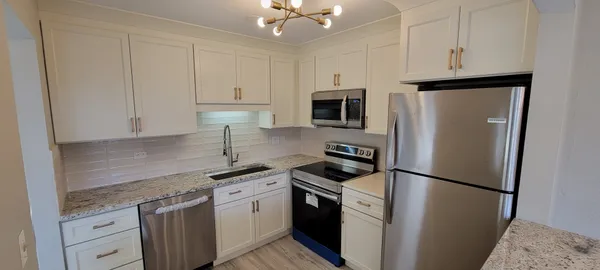 a kitchen with stainless steel appliances a refrigerator sink and cabinets