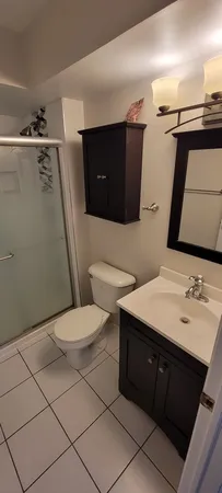 a bathroom with a sink vanity mirror and toilet