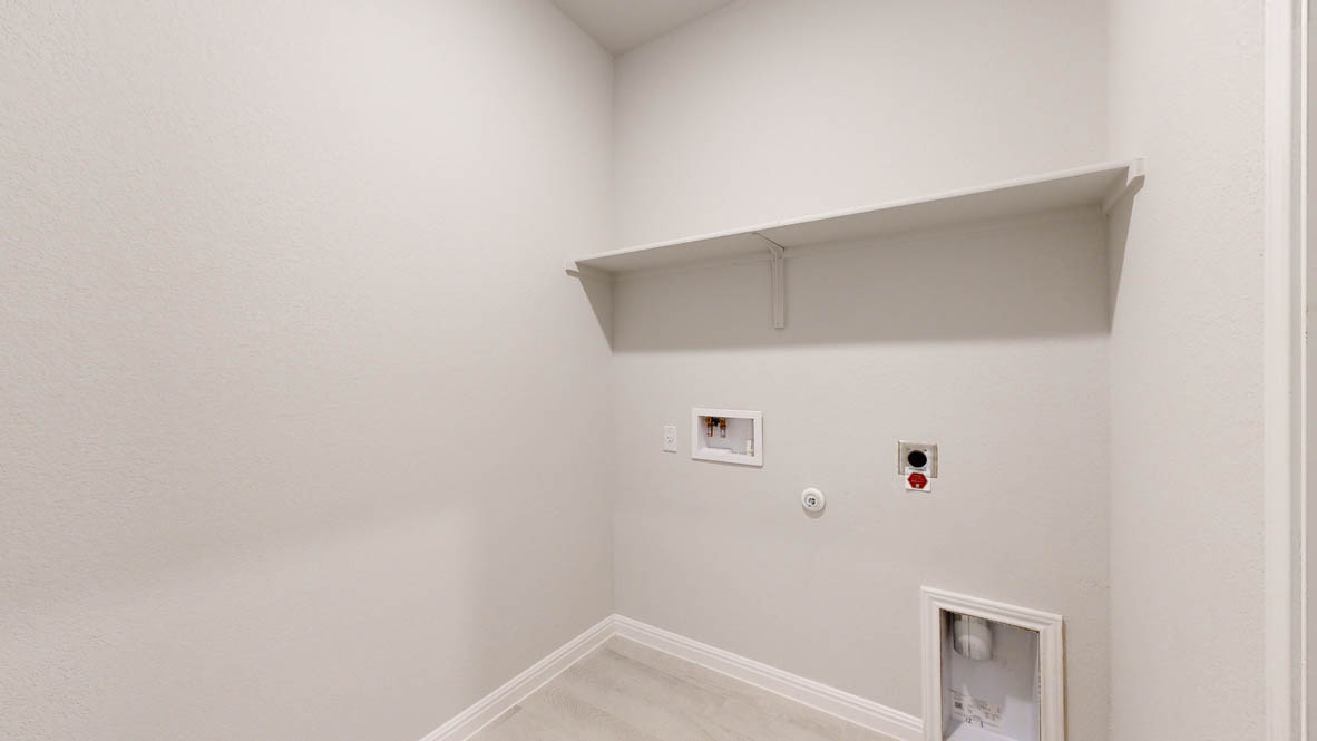 808 Gauge Road Thorndale, TX 76577 - Photo 31 of 31 A dedicated laundry space provides practical utility with an elevated storage shelf and essential hookups.