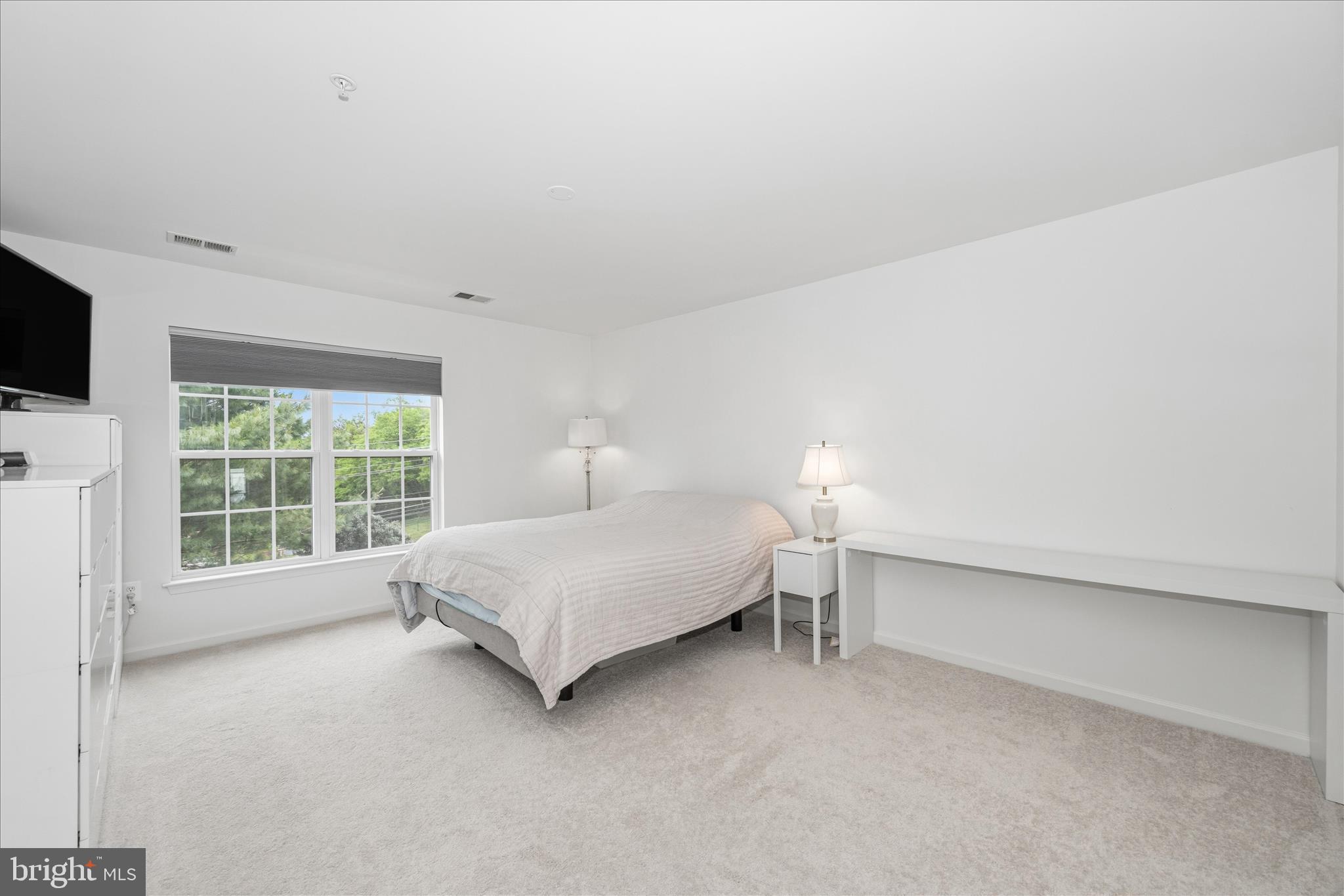21 Inkberry Circle Gaithersburg, MD 20877 - Photo 28 of 51 a spacious bedroom with a bed and a flat tv screen on the dresser