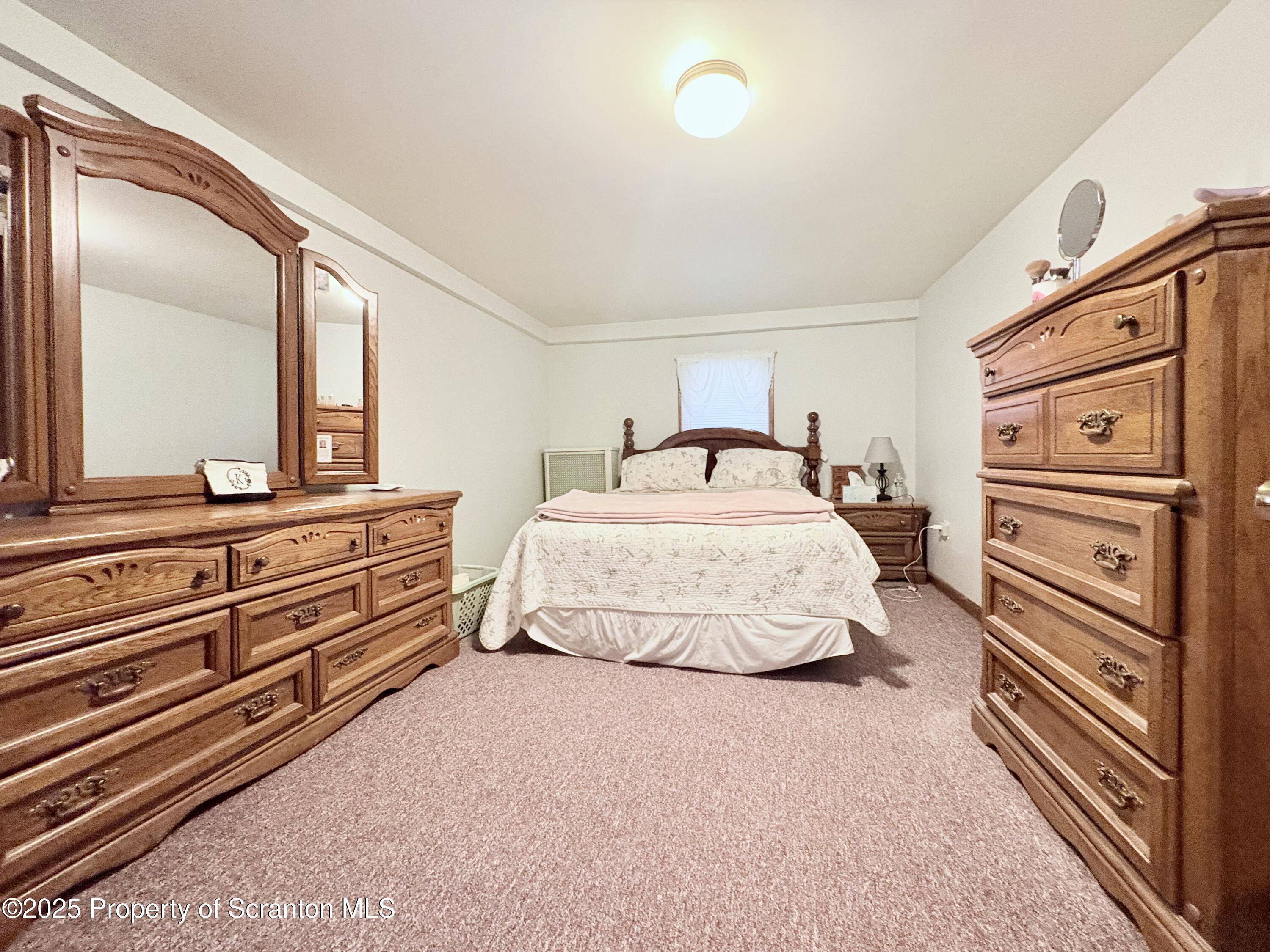 186 Cemetery Street Archbald, PA 18403 - Photo 16 of 28 a bedroom with a bed and wooden floor