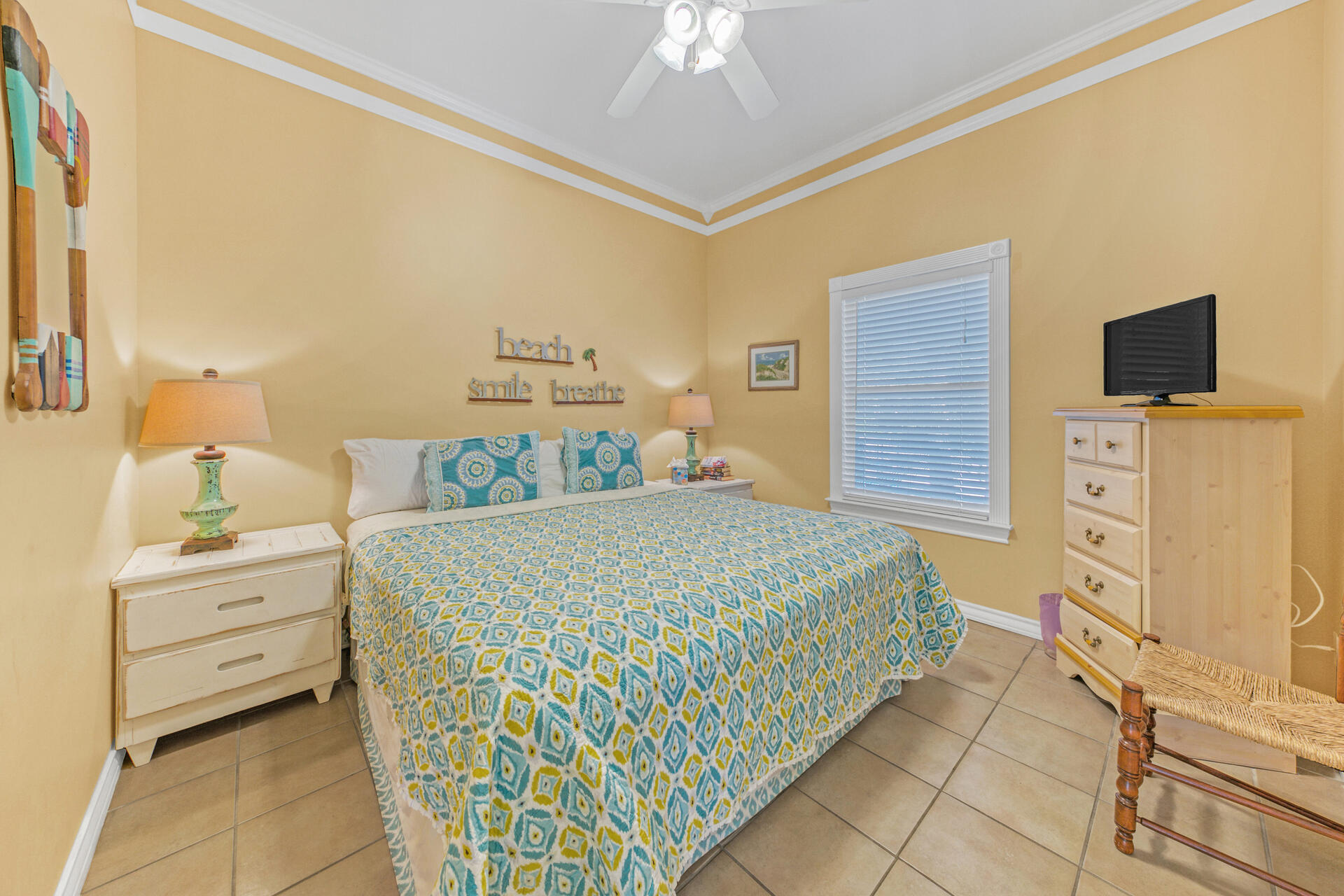 88 East Blue Crab Loop Panama City Beach, FL 32461 - Photo 16 of 55 a bedroom with a bed and a flat tv screen on dresser