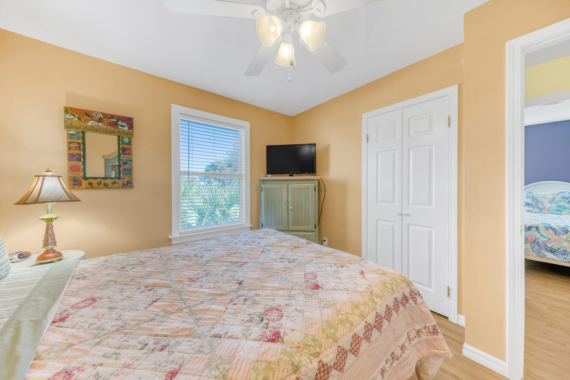 88 East Blue Crab Loop Panama City Beach, FL 32461 - Photo 21 of 55 a bedroom with a bed and a flat tv screen on dresser