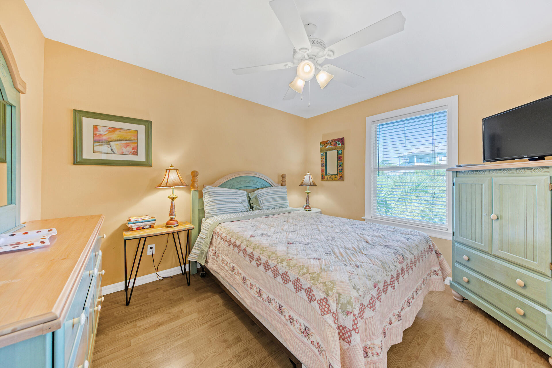 88 East Blue Crab Loop Panama City Beach, FL 32461 - Photo 22 of 55 a spacious bedroom with a bed and a flat screen tv