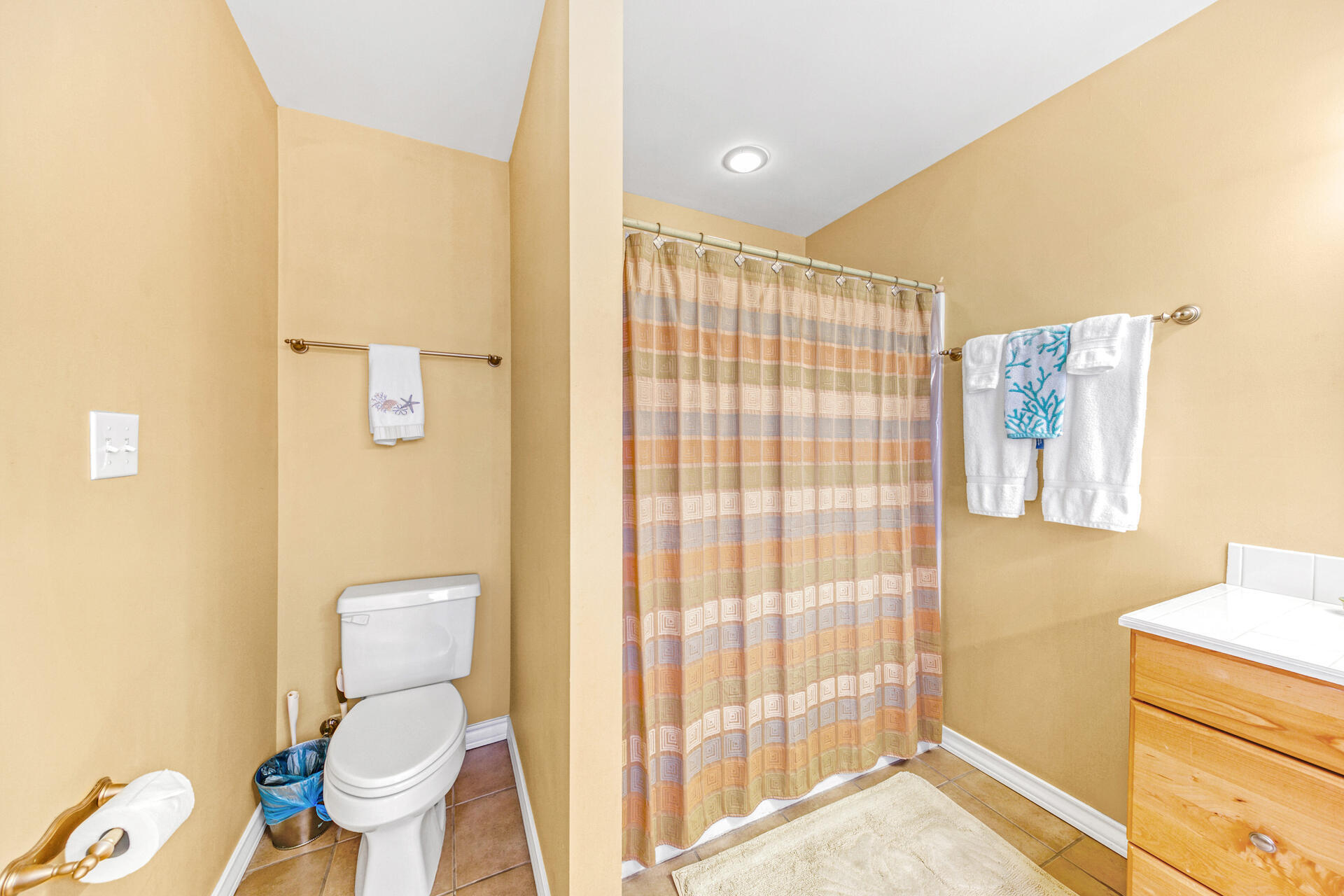 88 East Blue Crab Loop Panama City Beach, FL 32461 - Photo 26 of 55 a white toilet sitting next to a bathroom sink