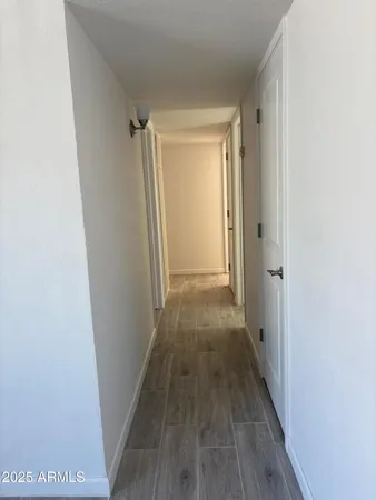 a view of a hallway with wooden floor