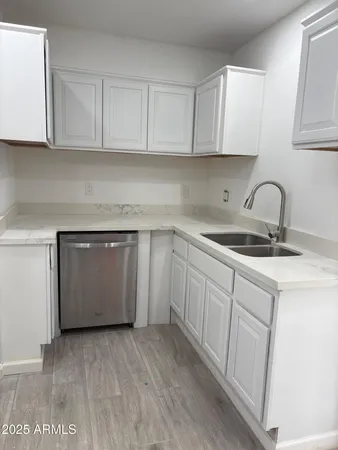 a kitchen with a sink cabinets and a window