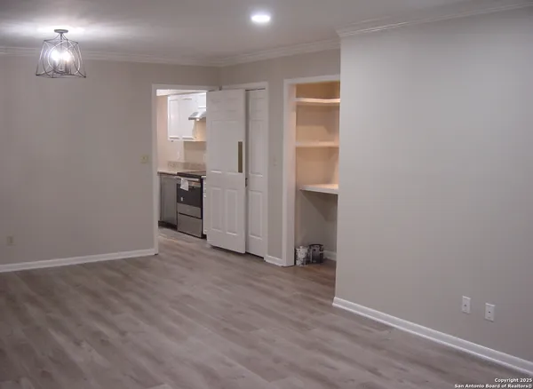 a view of a kitchen from a hallway