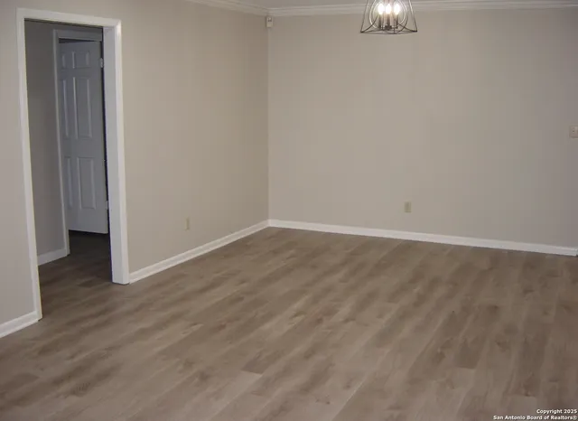 an empty room with windows and fireplace