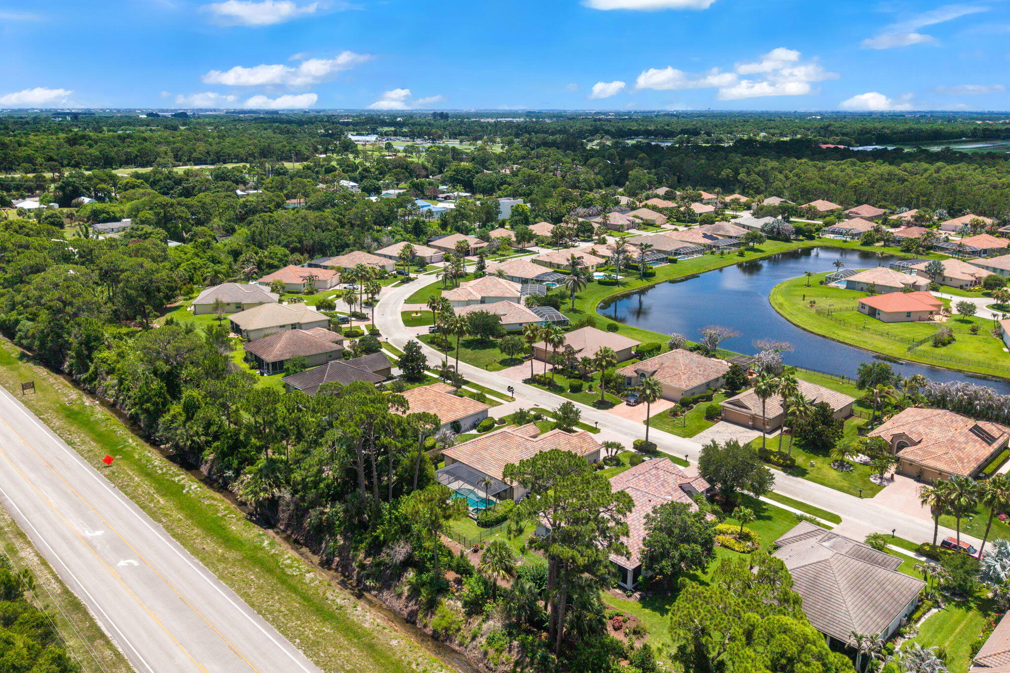 7657 Fieldstone Ranch Square Vero Beach, FL 32967 - Photo 48 of 52 a view of a city with lots of residential buildings ocean and mountain view in back