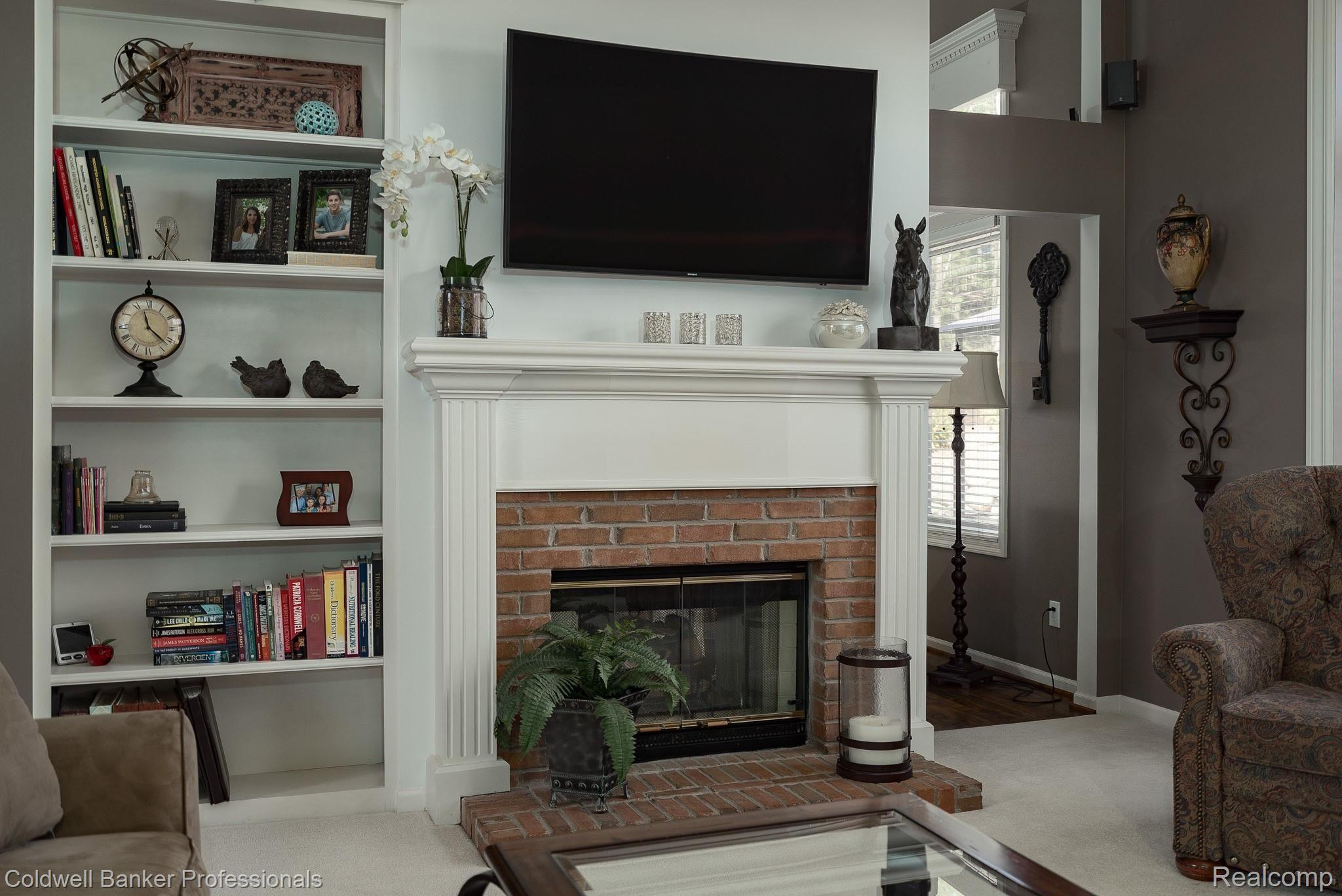 3822 Red Root Road Lake Orion, MI 48360 - Photo 9 of 42 2 way fireplace in Great Room that is shared to the kitchen nook area
