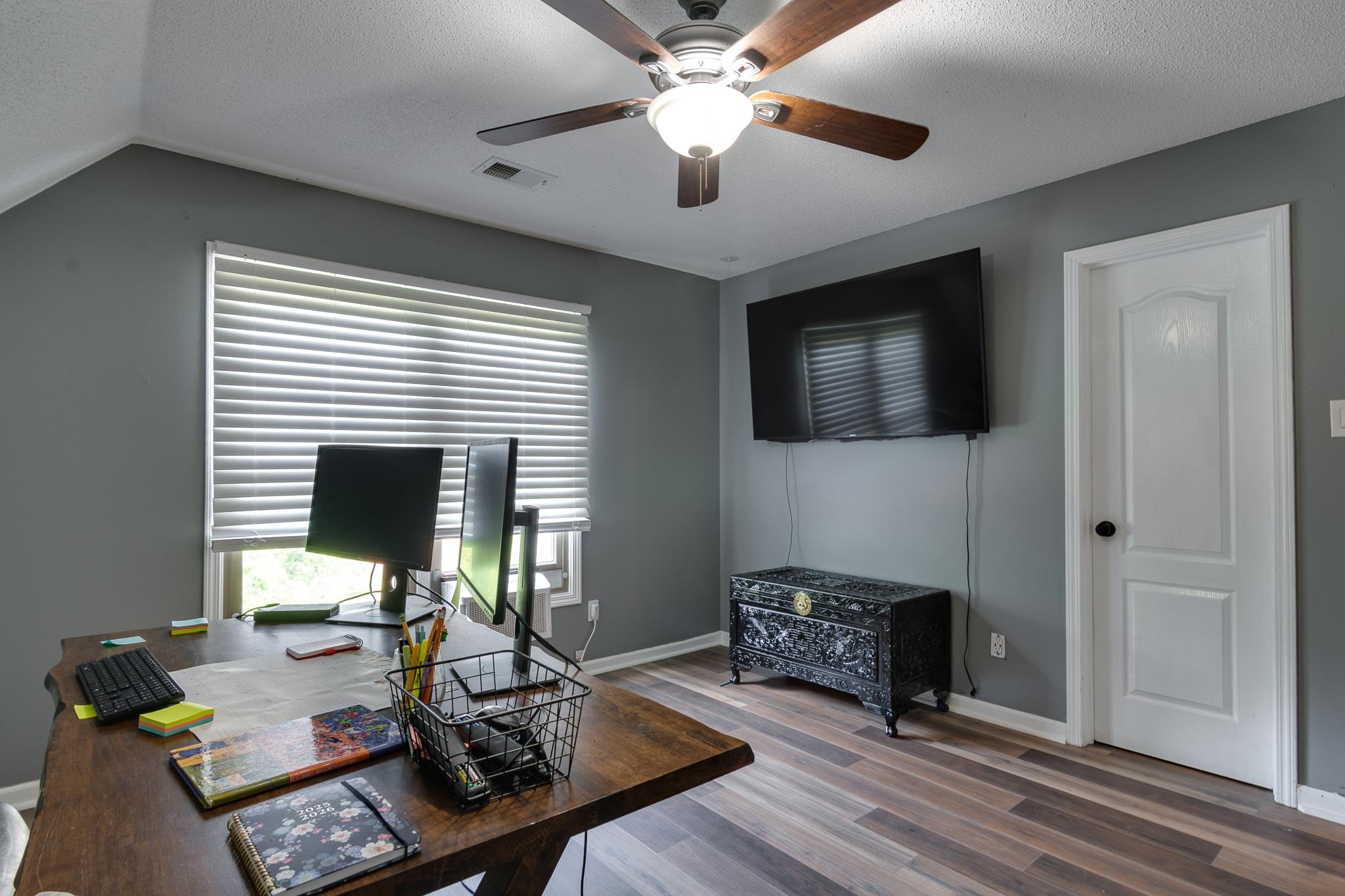 779 Early Earner Cove Collierville, TN 38017 - Photo 18 of 29 Room featuring wood-finish flooring, a ceiling fan with integrated lighting, and a window with horizontal blinds