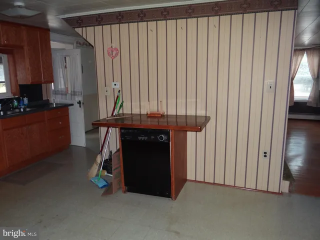 a view of a kitchen with furniture and a window