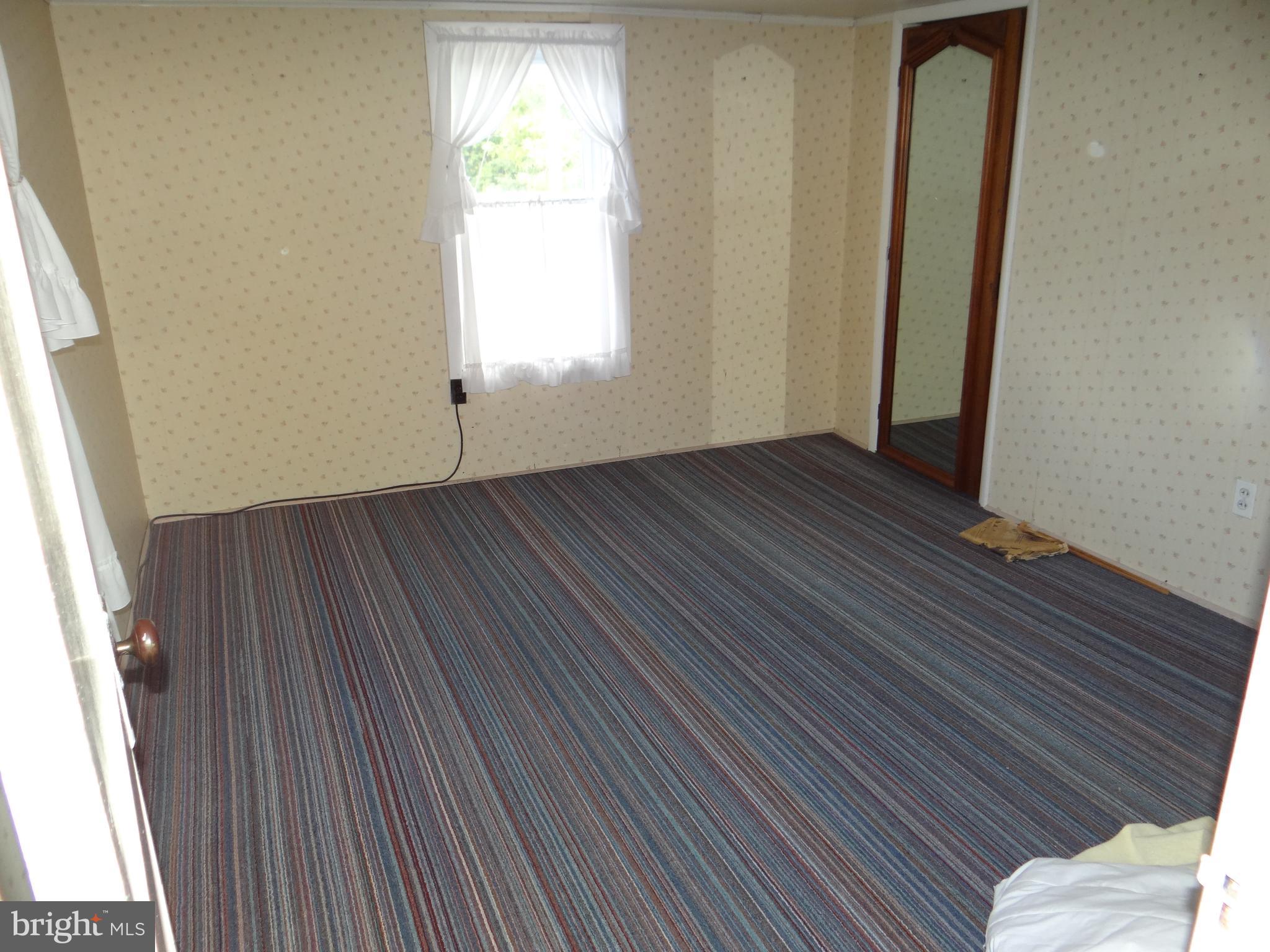 17247 Junkin Road Spring Run, PA 17262 - Photo 22 of 24 an empty room with wooden floor and windows