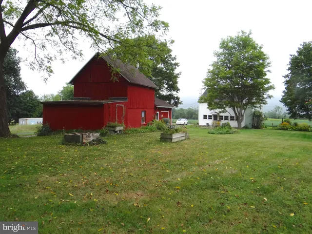 a view of backyard of house with green space