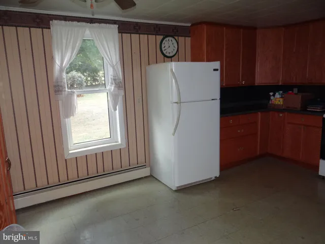 a white refrigerator freezer and a dishwasher sitting in a kitchen