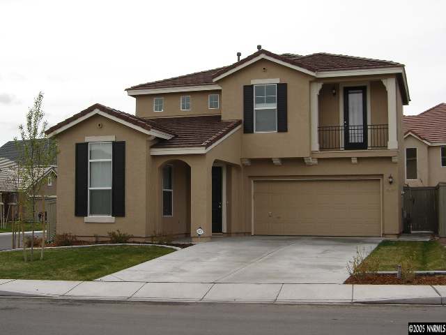 9100 Hummer Drive Reno, NV 89521 - Photo 1 of 9 a front view of a house with a yard and garage