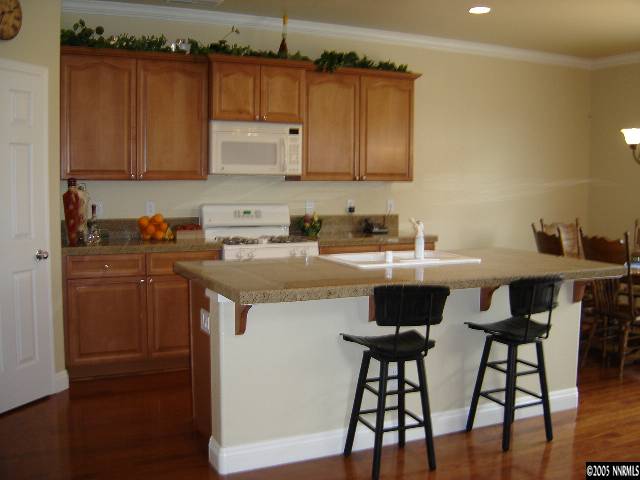 9100 Hummer Drive Reno, NV 89521 - Photo 2 of 9 a kitchen with a sink cabinets and wooden floor