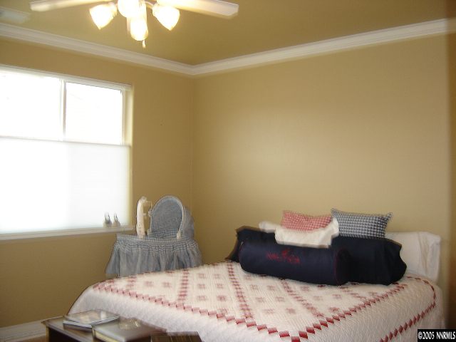 9100 Hummer Drive Reno, NV 89521 - Photo 8 of 9 a bedroom with a bed and a window