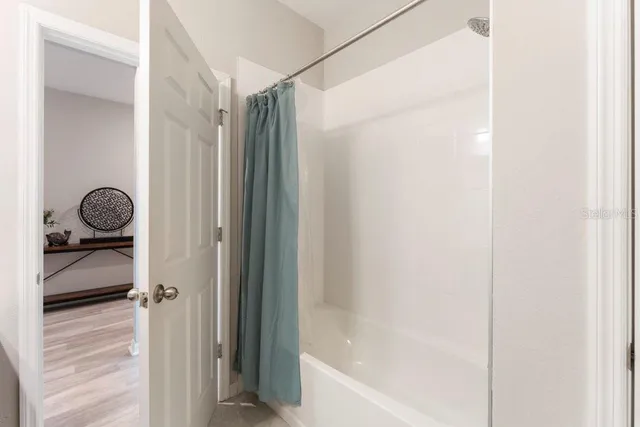 a bedroom with a bed and a table