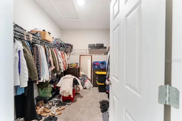 a view of a workspace with a table and chairs in a room