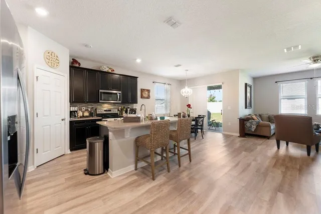 a kitchen with refrigerator and microwave