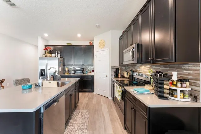 a kitchen with a dining table and chairs