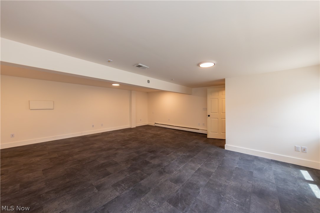 7969 Dines Road Novelty, OH 44072 - Photo 40 of 48 Spacious media room featuring dark plank flooring and light-toned walls