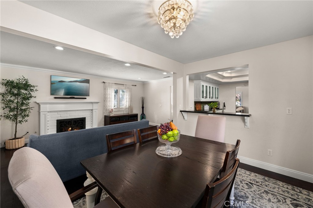 1274 Muirfield Road Riverside, CA 92506 - Photo 12 of 48 a view of a dining room with furniture a chandelier and wooden floor