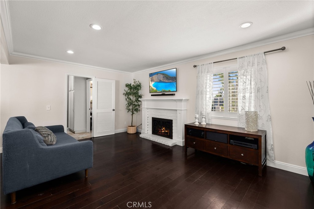 1274 Muirfield Road Riverside, CA 92506 - Photo 13 of 48 a living room with furniture a fireplace and a flat screen tv
