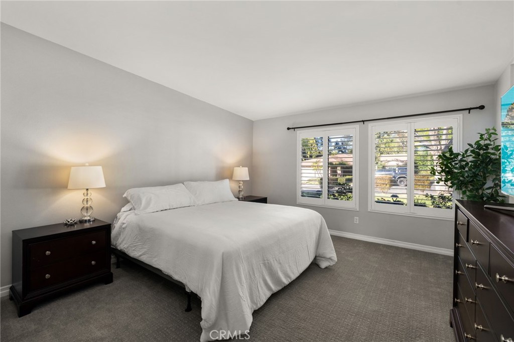 1274 Muirfield Road Riverside, CA 92506 - Photo 16 of 48 a bedroom with a large bed and a large window