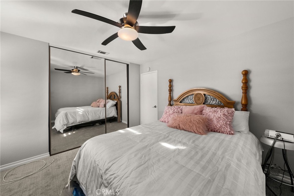 1274 Muirfield Road Riverside, CA 92506 - Photo 24 of 48 a bedroom with a bed and a ceiling fan