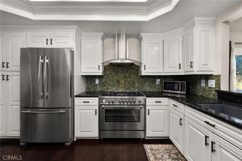 1274 Muirfield Road Riverside, CA 92506 - Photo 7 of 48 a kitchen with stainless steel appliances granite countertop a stove a refrigerator and a granite counter tops