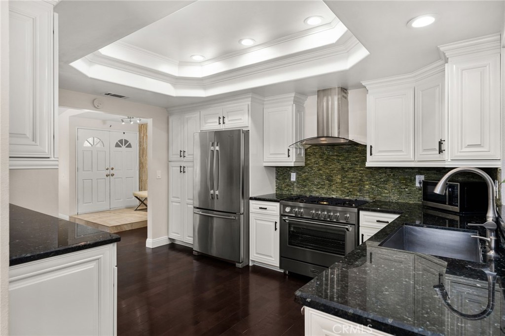 1274 Muirfield Road Riverside, CA 92506 - Photo 8 of 48 a kitchen with granite countertop a refrigerator stove and sink