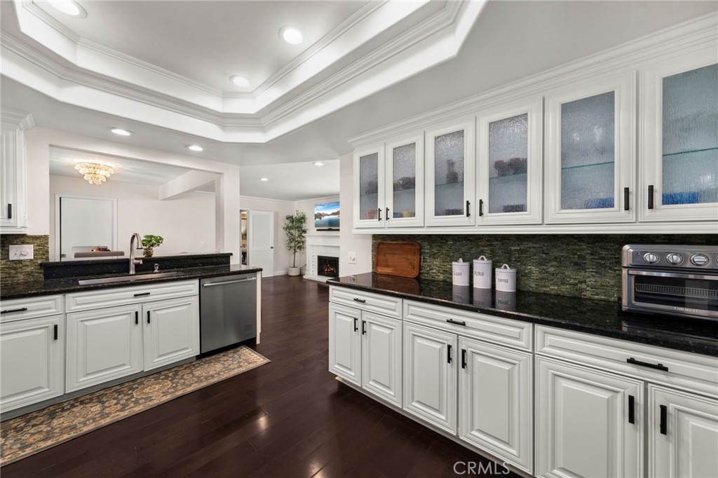 1274 Muirfield Road Riverside, CA 92506 - Photo 9 of 48 a kitchen with granite countertop white cabinets and white appliances